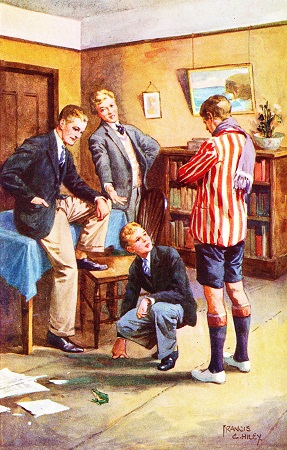 Colour image of four students and a green frog.